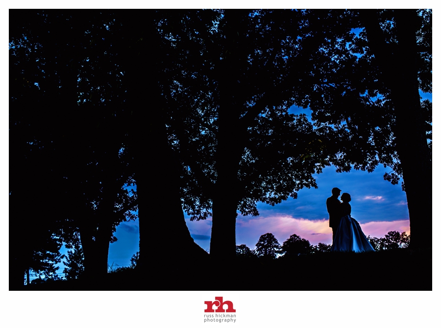 A newly married couple kiss in the sunset at The Manor House at Prophecy Creek Park Wedding.